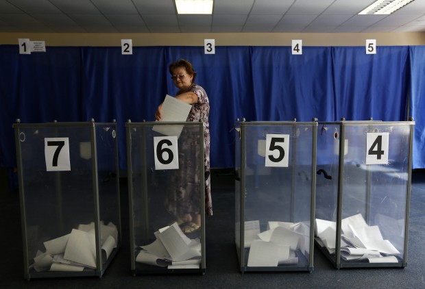A woman casts her ballot at a polling station during Ukraine's presidential elections in Krasnoarmeisk