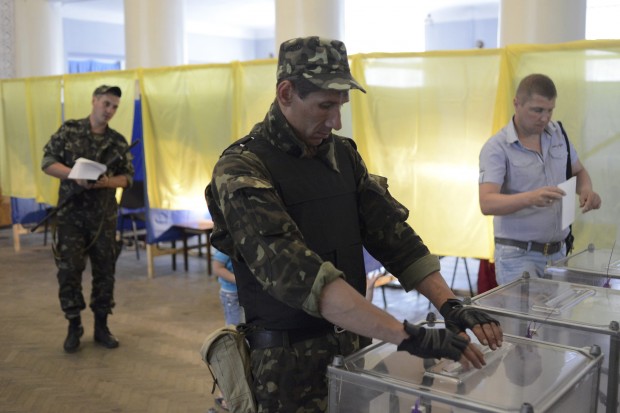 A Ukrainian soldier casts his ballot in a presidential election at a polling station in the village of Dobropillya
